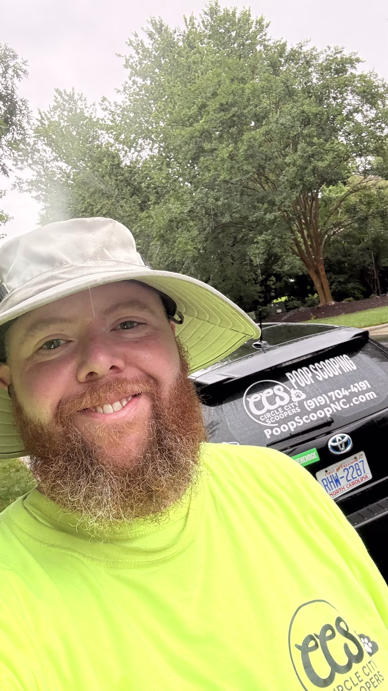 Nick from Circle City Scoopers beside the company service vehicle